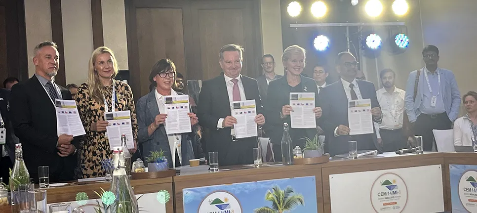 A group of people posing for a photo holding copies of the report.